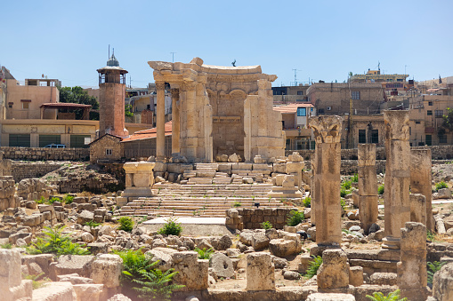 Baalbek temple complex in Lebanon. Massive Roman ruins. View of the columns and the Temple of Venus on the background of the modern city.