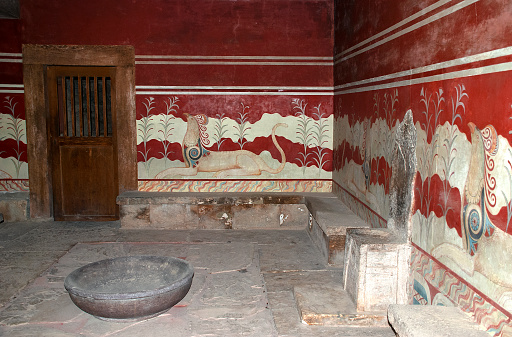 The Minoan alabaster throne is surrounded by beautiful murals in Knossos, Crete, Greece.